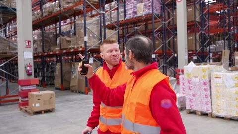 Warehouse workers using barcode scanner and radio Stock Footage 312856307