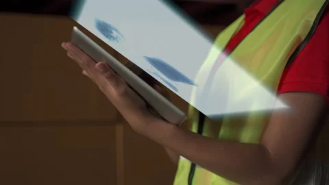 Warehouse workers using tablets to discuss holograms with warehouse management. Stock Footage 148020483