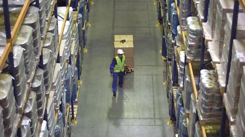 Warehouse workers walking between racks with merchandise Stock Footage 75986783