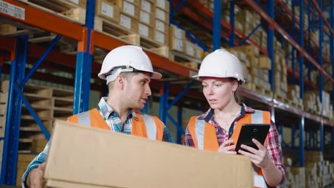 Warehouse workers working in a large distribution center Stock Footage 164238063