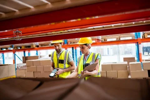Warehouse workers working together in a warehouse Photos