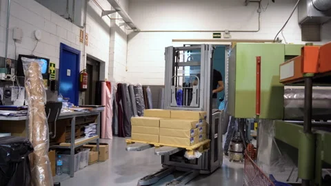 Warehouse working class labor  using an electric lifter for moving boxed Stock Footage 263542326