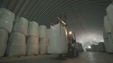 Warehousing. Forklift driver stacking big bag of raw material in warehouse. Stock Footage