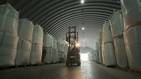 Warehousing. Forklift driver stacking big bag of raw material in warehouse. Stock Footage 146279507