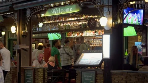 Warm and Inviting Bar Pub Restaurant Scene with Soccer Match on TV Stock Footage 248928959