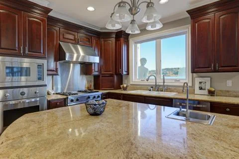 Warm and inviting kitchen with large kitchen island Stock Photos