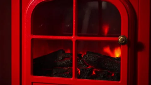 A warm and inviting winter scene with a retro red fireplace. Stock Footage 328409271