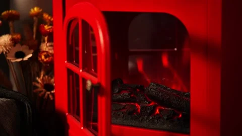 A warm and inviting winter scene with a retro red fireplace. Stock Footage 328409717