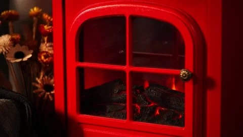A warm and inviting winter scene with a retro red fireplace. Stock Footage 328409787