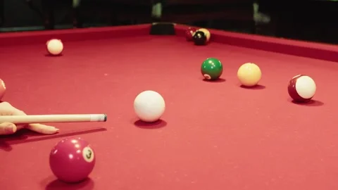 Warm atmosphere emphasizing precise cue handling and billiard balls on table Video stock 329192768