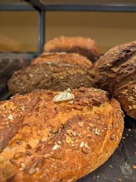 Warm Bakery Scene With Seeded Bread. Inviting Scene Of Freshly Baked Multig.. Stock Photos