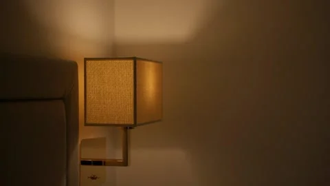 Warm bedside lamp glowing at night Stock Footage 306329764