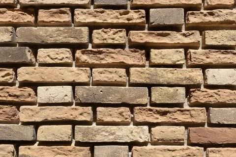 Warm Beige Brick Wall Texture in Sunlight Stock Photos