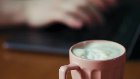 Warm Beverage Mug on Table next to Laptop Stock Footage 346632893