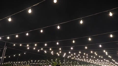Warm Bistro String Lights Overhanging an Outdoor Space Stock Footage 324945502
