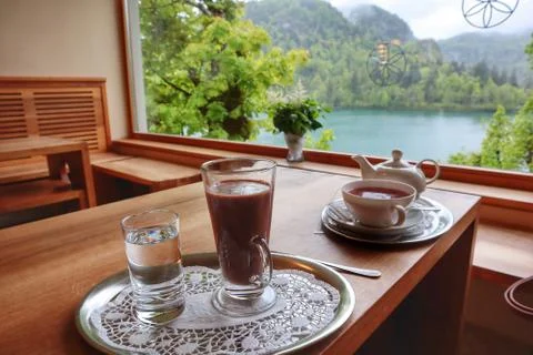 Warm brew in a cafe with the lake view Stock Photos