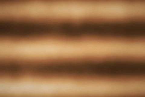 Warm brown gradient background featuring soft horizontal blurs and noise te.. Stock Photos