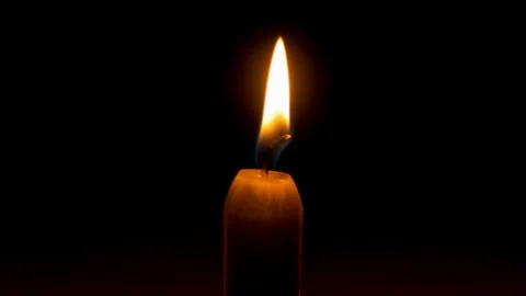 Warm Candle stable flame on black background with rim light Stock Footage 122863502