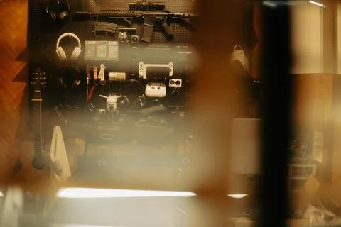 Warm Cinematic Desk Setup Viewed Through Window Blinds at Night Stock Photos
