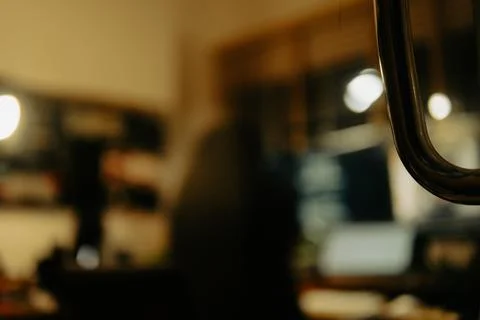 Warm Cinematic Desk Setup Viewed Through Window Blinds at Night Stock Photos
