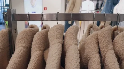 Warm clothes on a hanger in the store. Video stock 218474333
