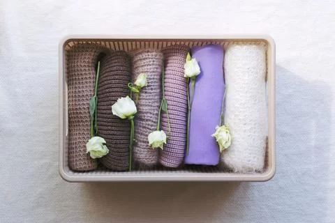 Warm clothes in a wicker box Stock Photos