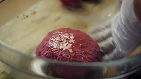 Warm cook peeling a roasted beet from crinkled foil in tight shot, 4K Stock Footage 341111723