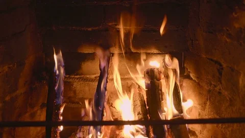 Warm cozy burning fire in a brick fireplace close up Stock Footage 73534246