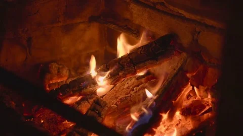 Warm cozy burning fire in a brick fireplace close up Stock Footage 74678240