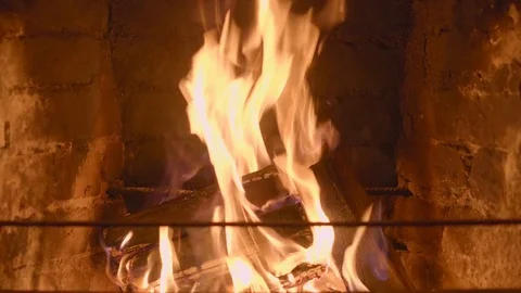 Warm cozy burning fire in a brick fireplace close up Stock Footage 74872786