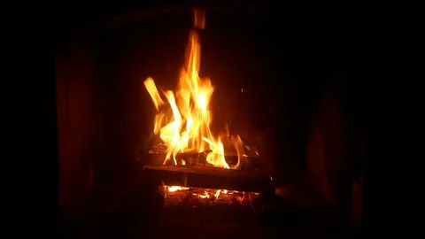 Warm cozy burning fire in a brick fireplace, close-up shot Stock Footage 151995299
