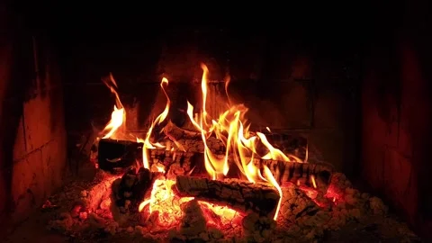 Warm cozy burning fire in a brick fireplace, close-up shot Stock Footage 314654641