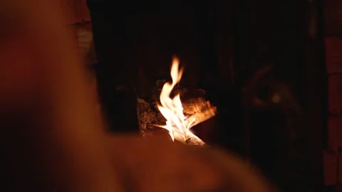Warm cozy fire in the fireplace. Logs against a background of crackling fire. Stock Footage 148374844