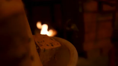 Warm cozy fire in the fireplace. Logs against a background of crackling fire. Stock Footage 148374855