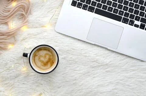 Warm cozy winter workspace with coffee and notebook on fur fluffy white Stock Photos
