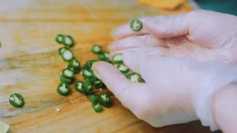 Warm culinary moment: cutting green chili into rings Stock Footage 342172859