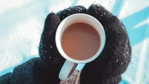 Warm cup of hot coffee warming in the hands of a girl Stock Photos