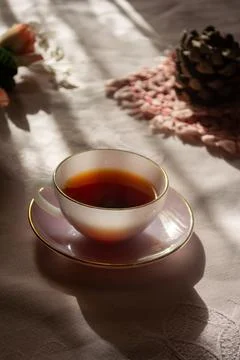 A warm cup of tea sits on a delicate saucer, Stock Photos