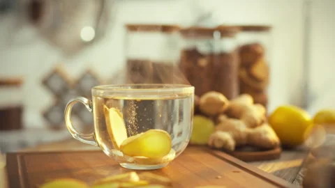 On a warm day a steaming ginger tea infused with minerals is surrounded by f Stock Footage 331365864