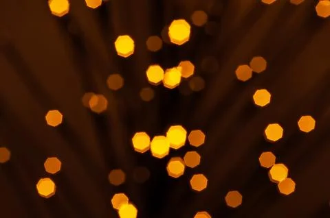 Warm, diffused, yellow lights shine against a dark background, creating a cel Stock-Fotos