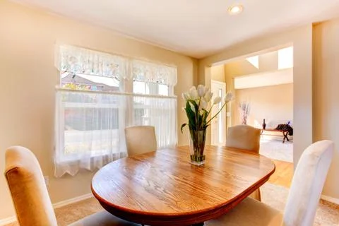 Warm dining room in soft ivory Stock Photos