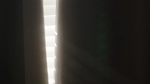 Warm Dreamy Light Shining Through Black Curtains Panning Up 4K Stock Footage 170921926