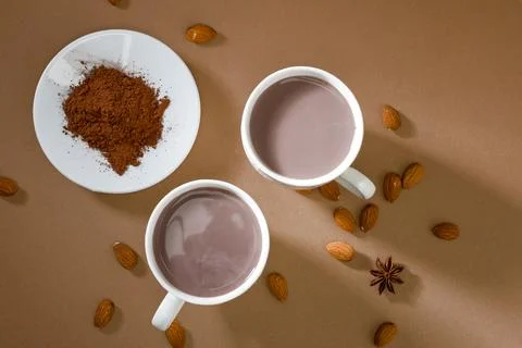 Warm drinks and spices on a table with brown background in a cozy kitchen s.. Stock Photos