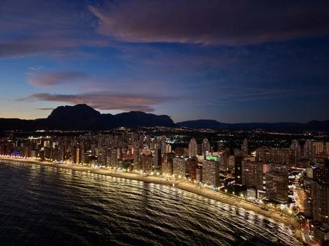 Warm evening scenes by tranquil coastlines, serene sunset over hills and Stock Photos