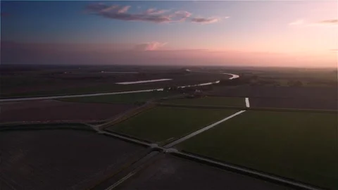 Warm Evening Sun Over Flat Dutch Farmland with Dike Stock Footage 275156462
