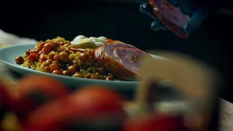Warm festive pilaf crowned with sliced meat and boiled eggs in macro, 4K Stock Footage 341113322