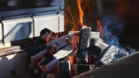 Warm fire burning on a grill. Logs glowing with orange flames. Stock-Footage 327692555
