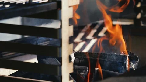 Warm fire burning on a grill. Logs glowing with orange flames.  Stock Footage 327692565