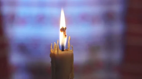 Warm flame of a wax candle close up Stock Footage 145367713