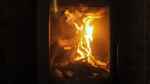Warm flames dance in the fireplace, creating a cozy atmosphere on a chilly Stock Footage 304027932